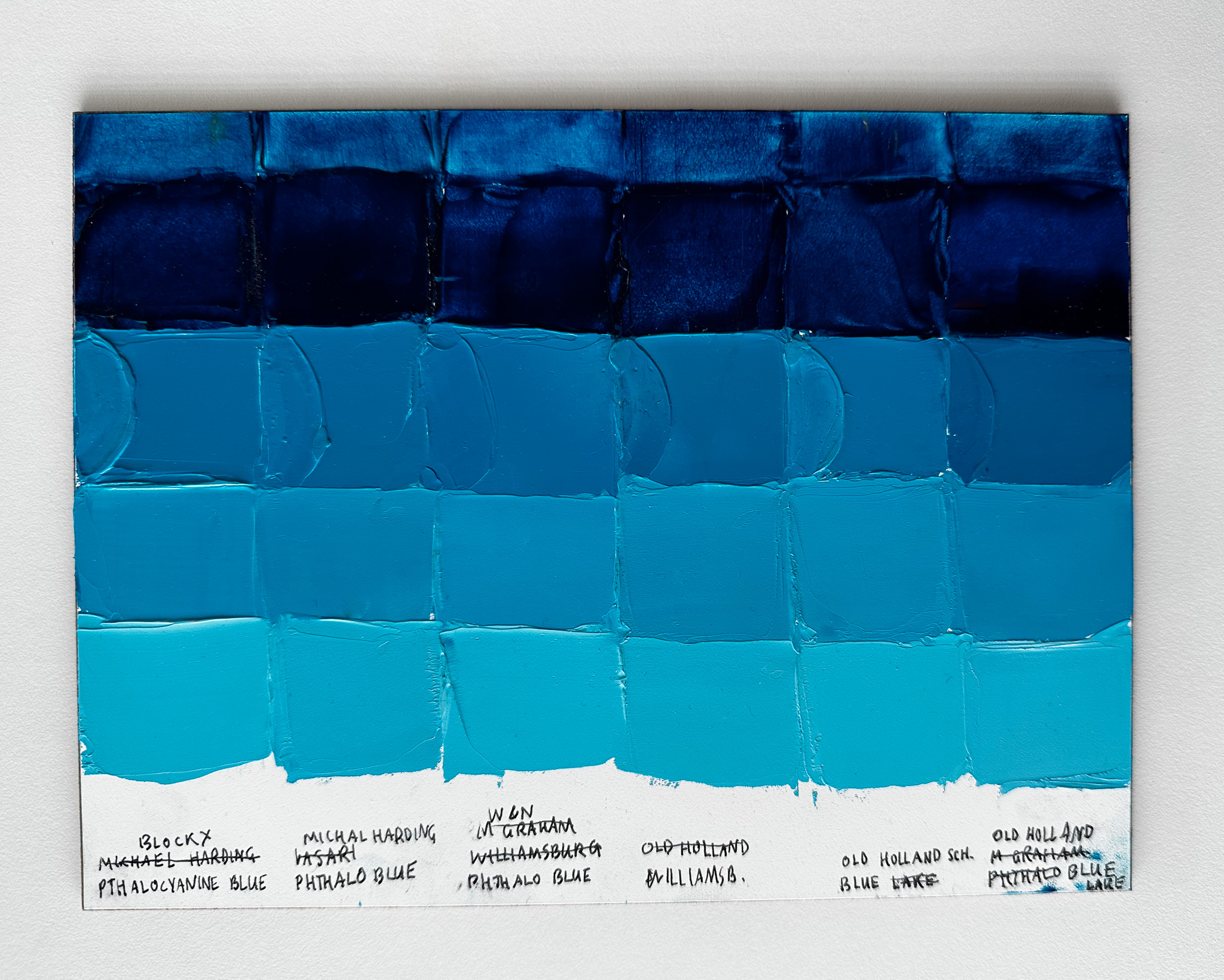 Color comparisons of several different artist paints made of phthalo blue green shade. Brands shown are Blockx, Michael Harding, Winsor and Newton, Williamsburg, and two paints from Old Holland