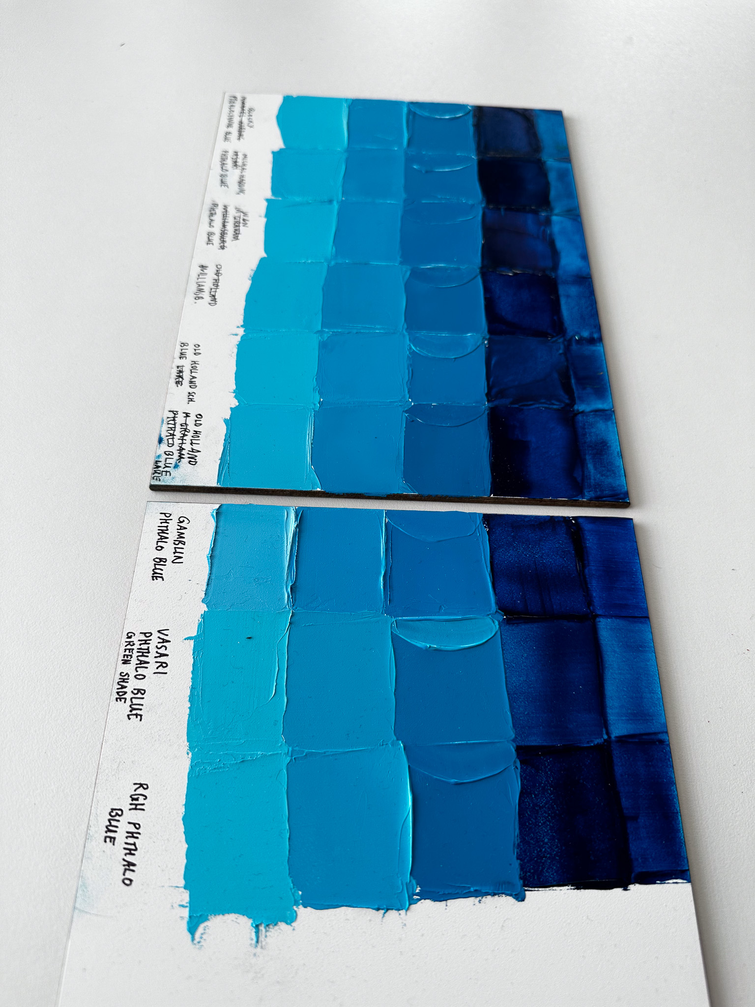 Bright blue paint swatches comparing Phthalo Blue Green Shade in oil paints. Paints shown are by Old Holland, Williamsburg and other paintmakers.
